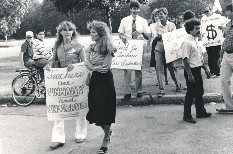 Picketers with signs supporting the Weymouth strike.