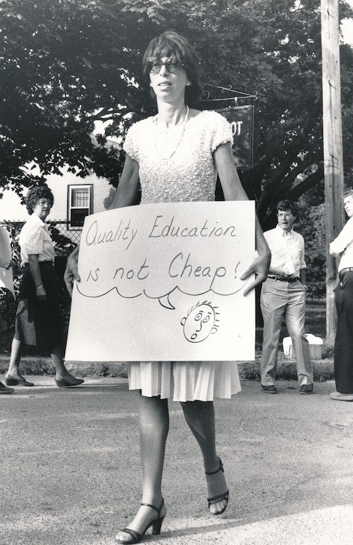 Picketer with sign supporting the Weymouth strike.