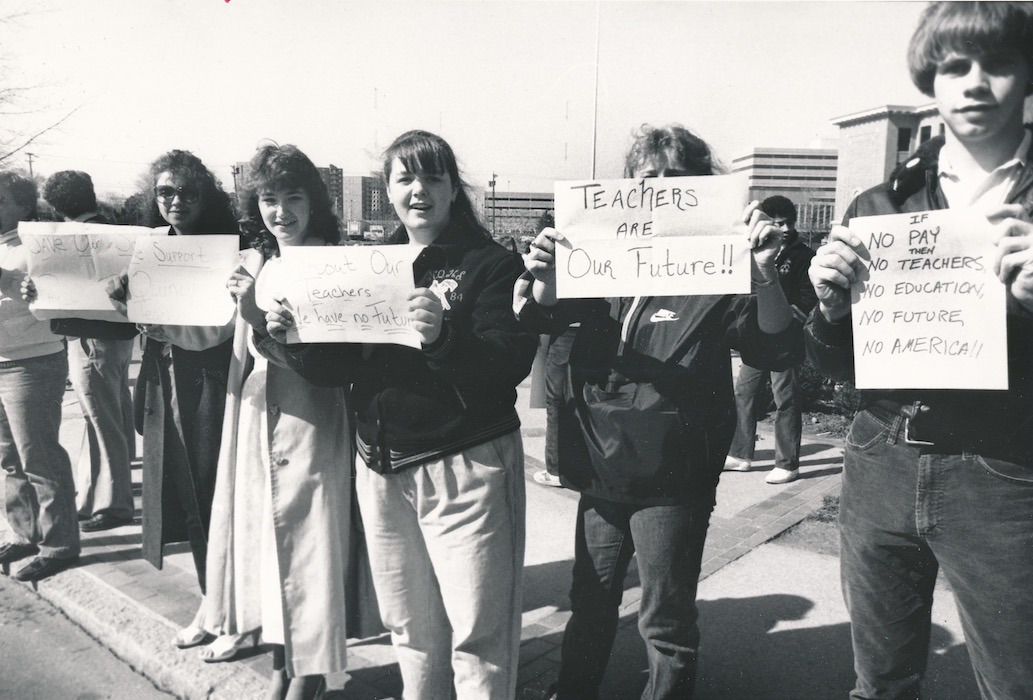 Line of people holding signs supporting strike.