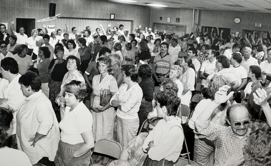 Crowd of teachers standing in a room.