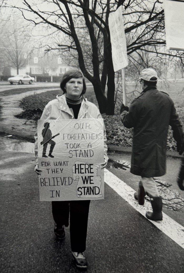 Picketers crossing a street holding signs supporting the Lexington strike.