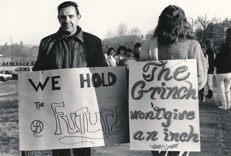 Two people wearing signs supporting Hudson strike.