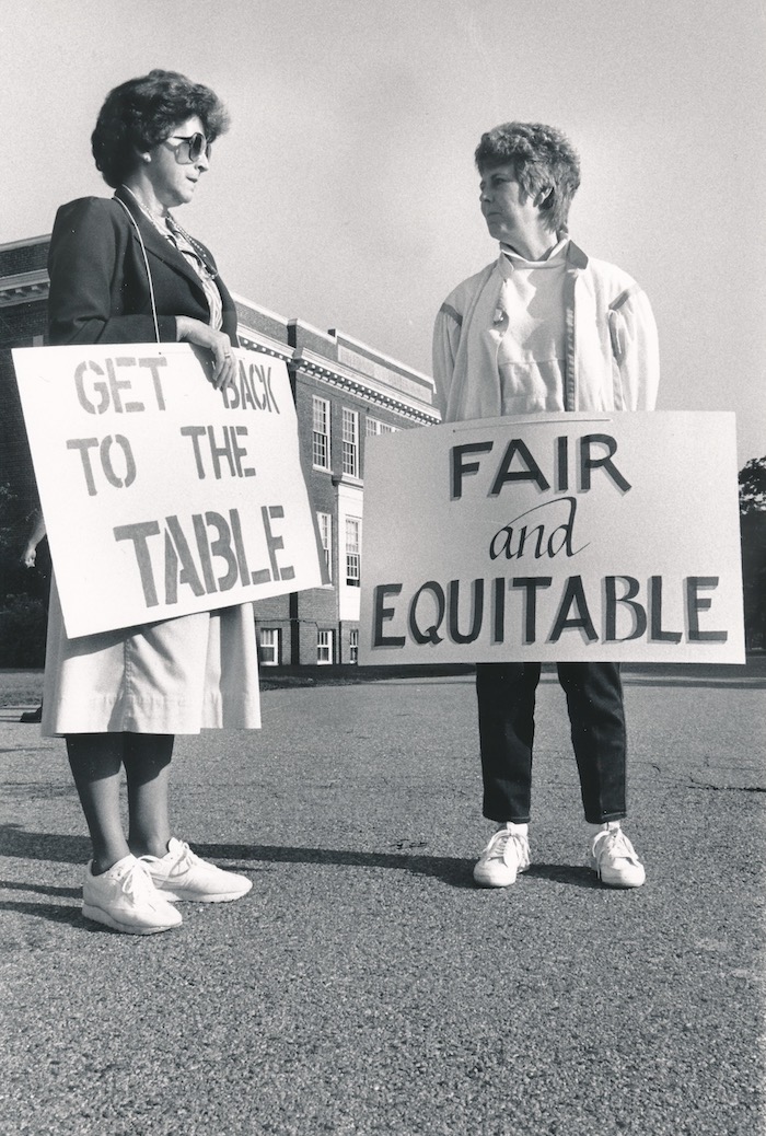 Two people holding signs supporting Hanover strike.