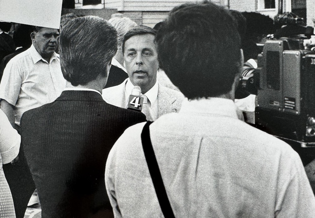 Camera man and reporter interviewing Richard Liston.