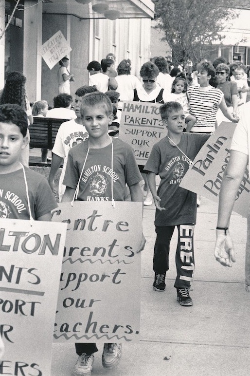 Children holding signs in picket line.