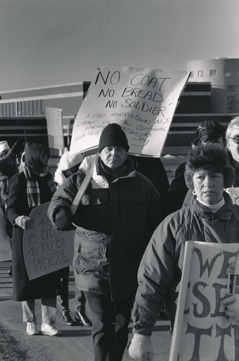 Picketers holding signs supporting the strike.