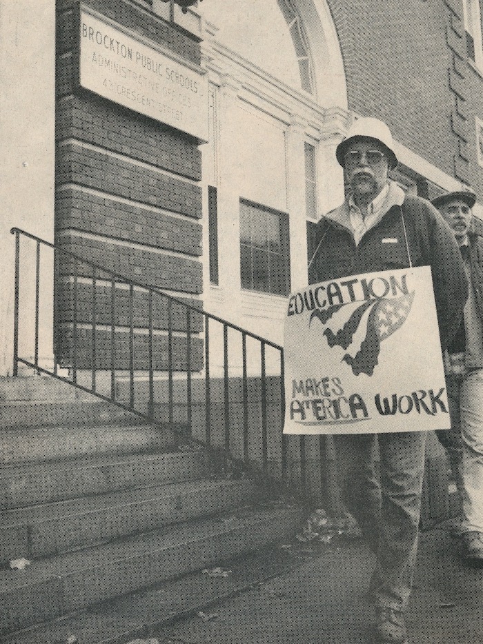 Picketer wearing a sign supporting the Brockton strike.