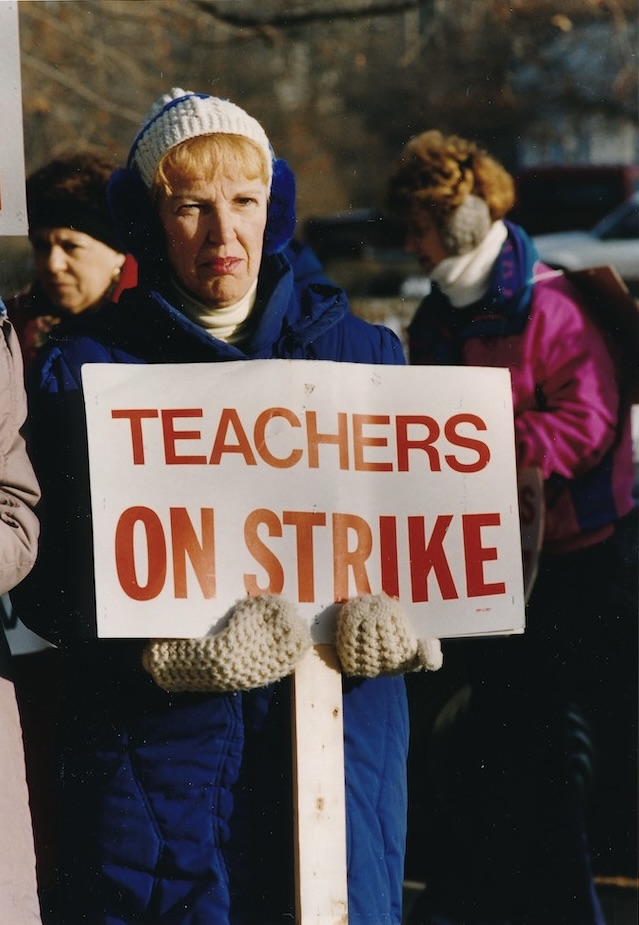 Picketer holding a sign supporting the Tewksbury strike.