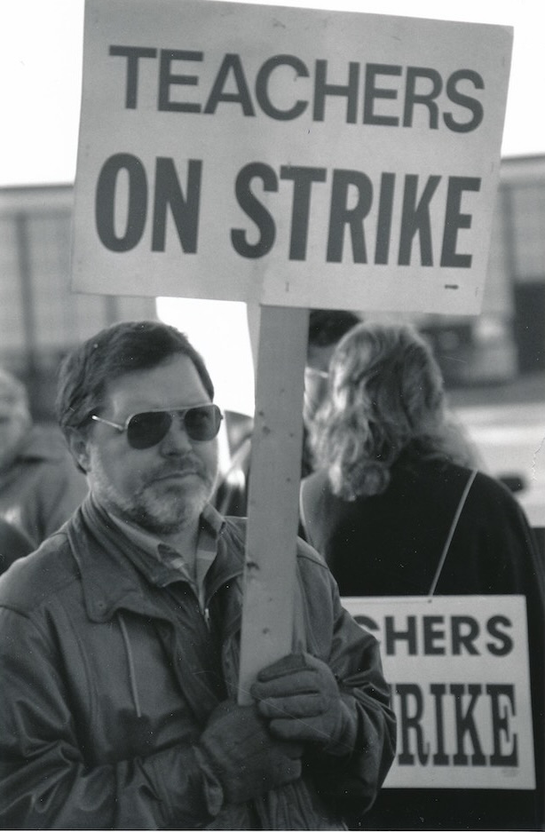 Richard Mousseau holding a sign supporting the Tewksbury strike.