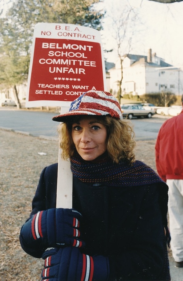 Toby Vogel holding a sign supporting the Belmont strike.
