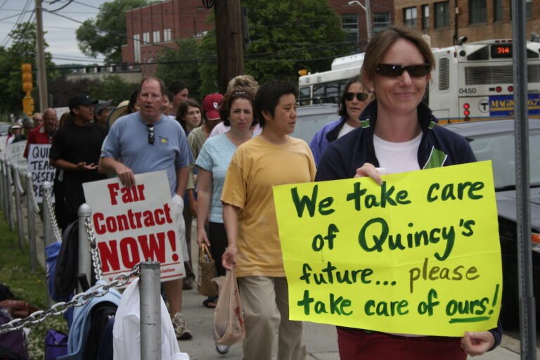 Picket line with posters supporting Quincy strike.
