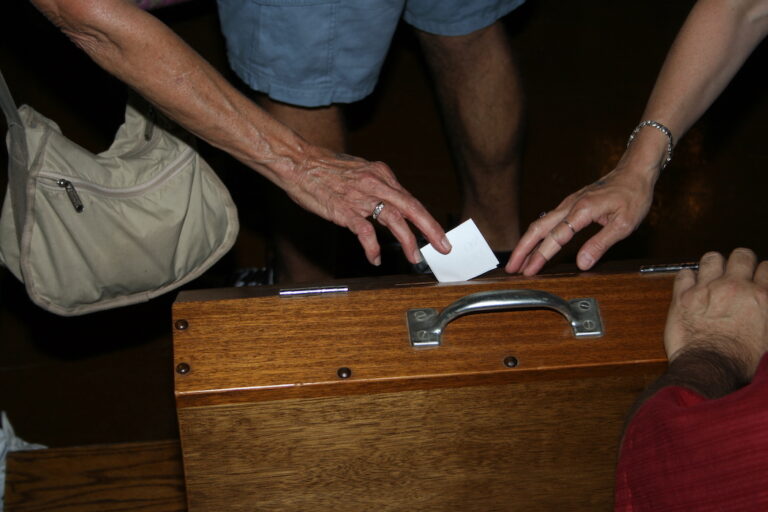 Ballot being submitted to ballot box.
