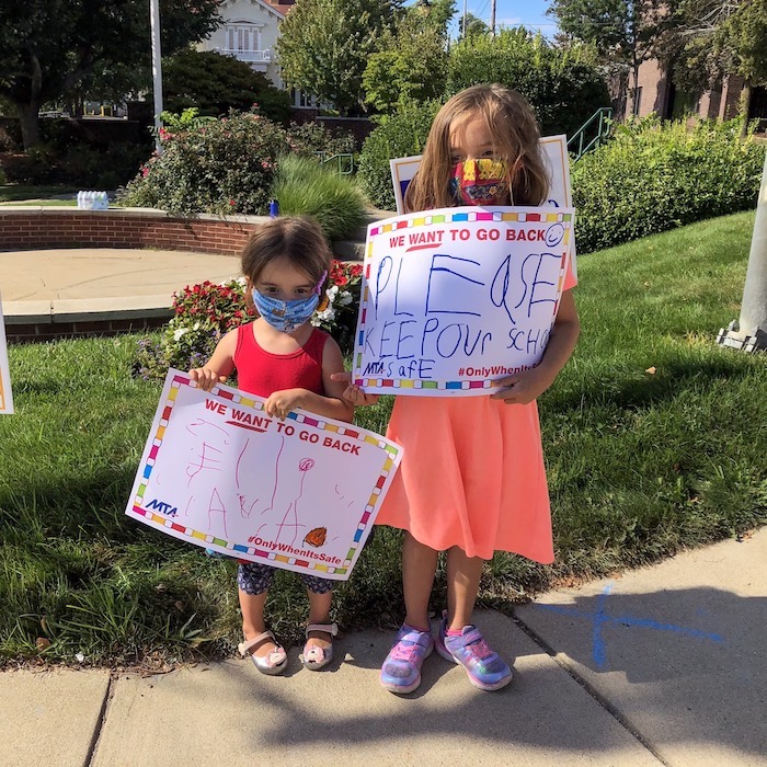 Two children holding signs supporting the Andover strike.