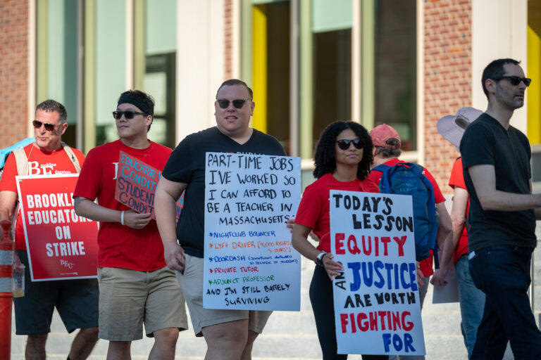 Picketers holding signs supporting the Brookline strike.