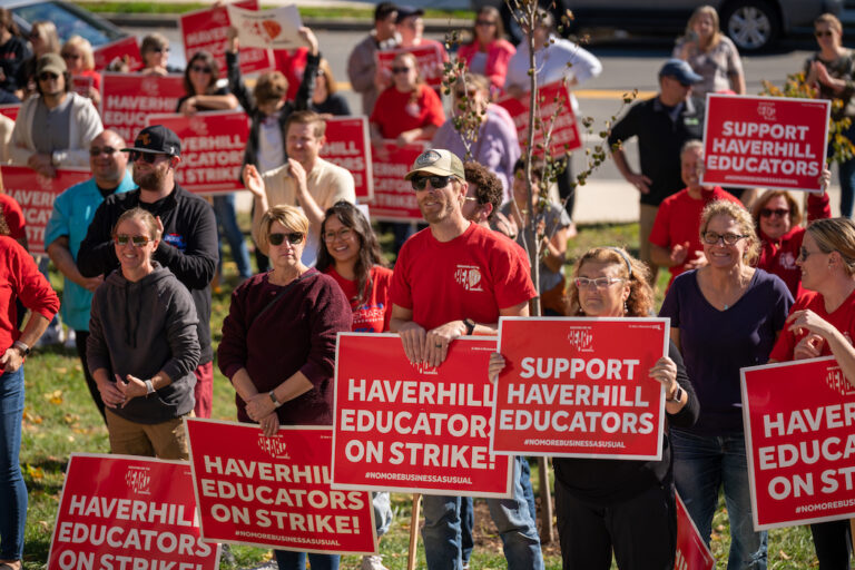 Crowd of picketers holding red signs supporting the Haverhill strike.