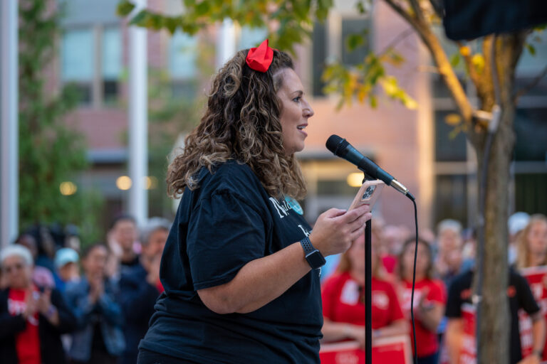 Deb Gesualdo standing in front of a microphone.