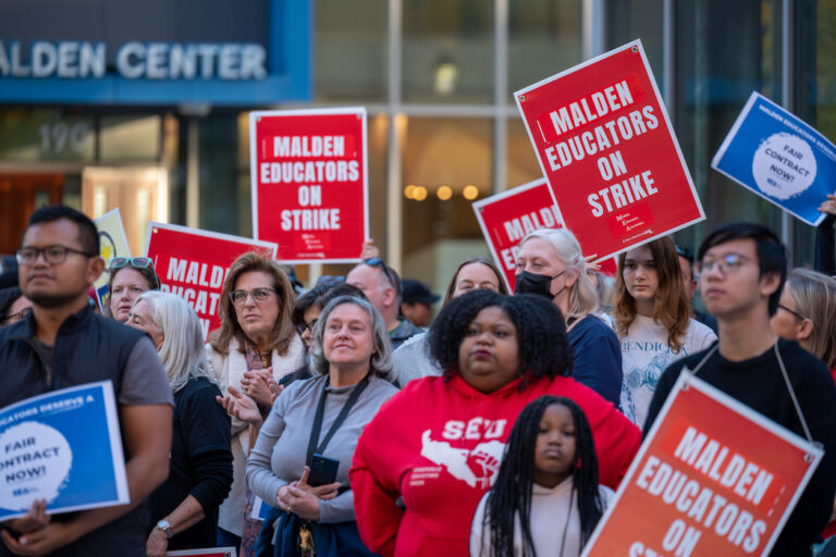 Crowd of picketers with signs supporting the Malden strike.