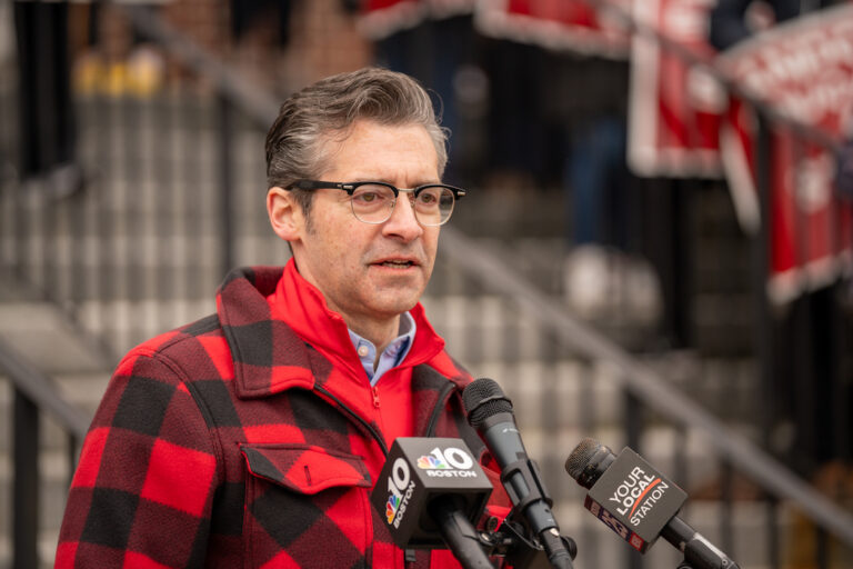 Matt Bach standing in front of numerous microphones.