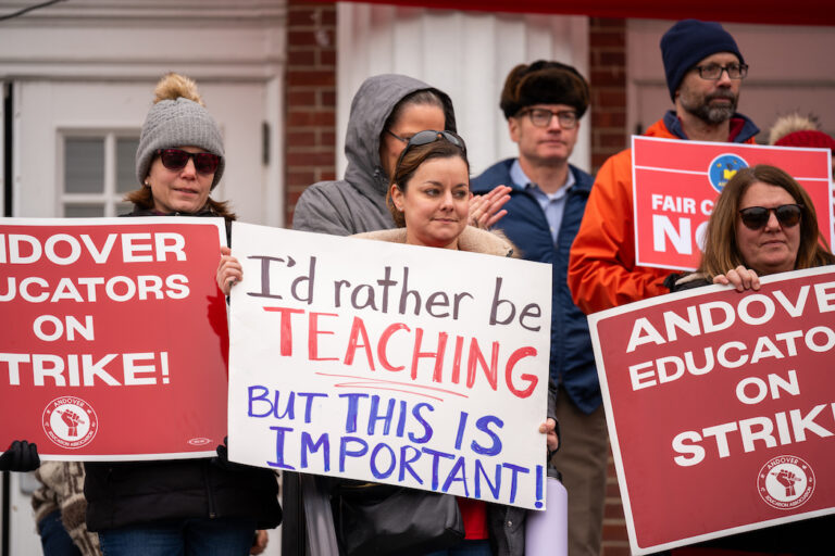 People hold signs supporting Andover strike.