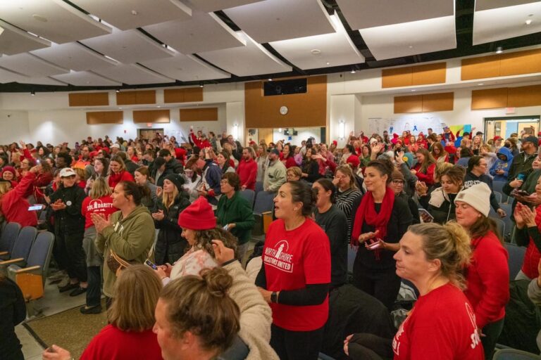 crowd of Beverly teachers applauding.