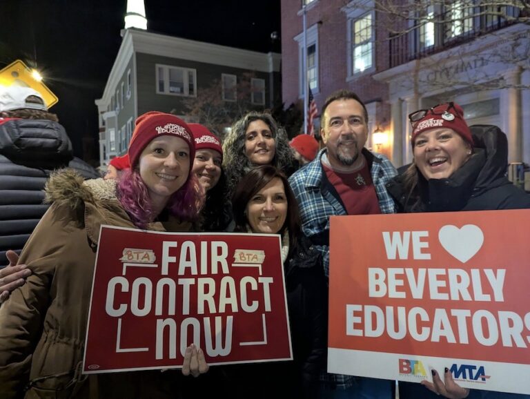 Picketers holding signs supporting the educator strikes.