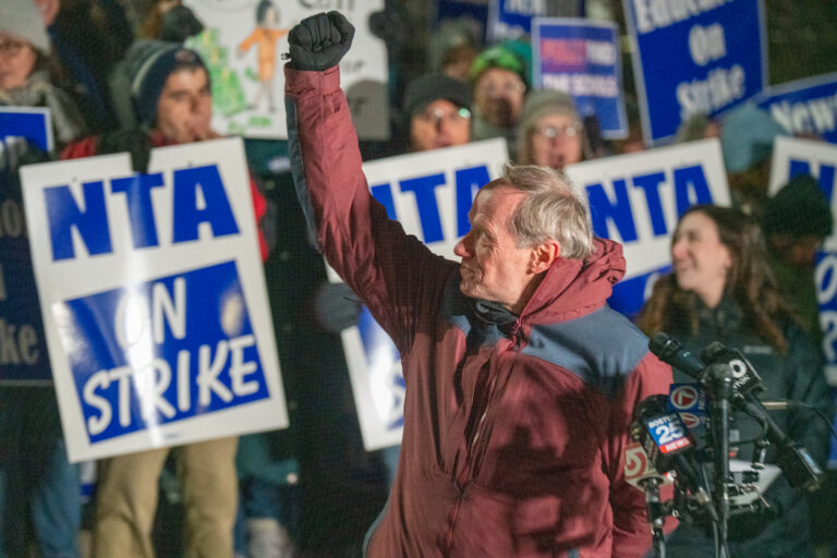 Mike Zilles standing in front of crowd with his fist raised.