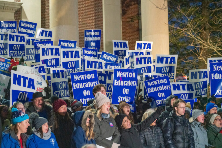 Crowd of picketers with signs supporting the Newton strike.