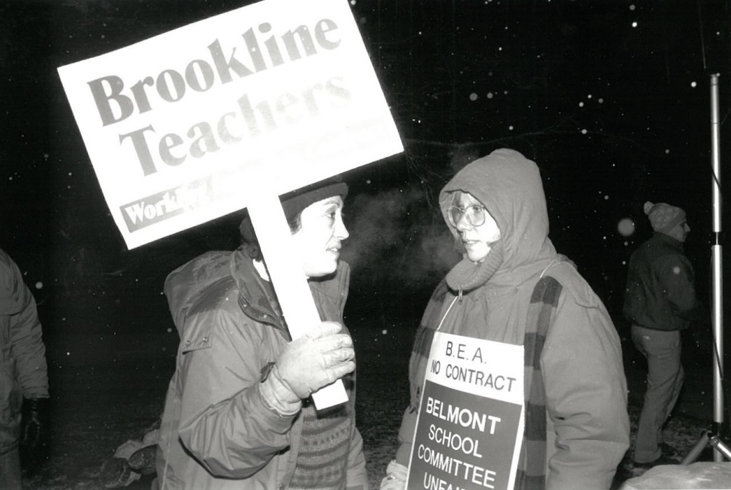 Two picketers with signs supporting the Belmont strike.