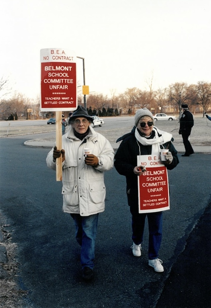 Two picketers with signs supporting the Belmont strike.