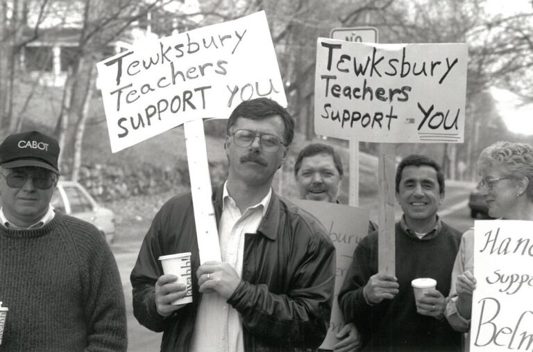 Picketers with signs supporting the Belmont strike.