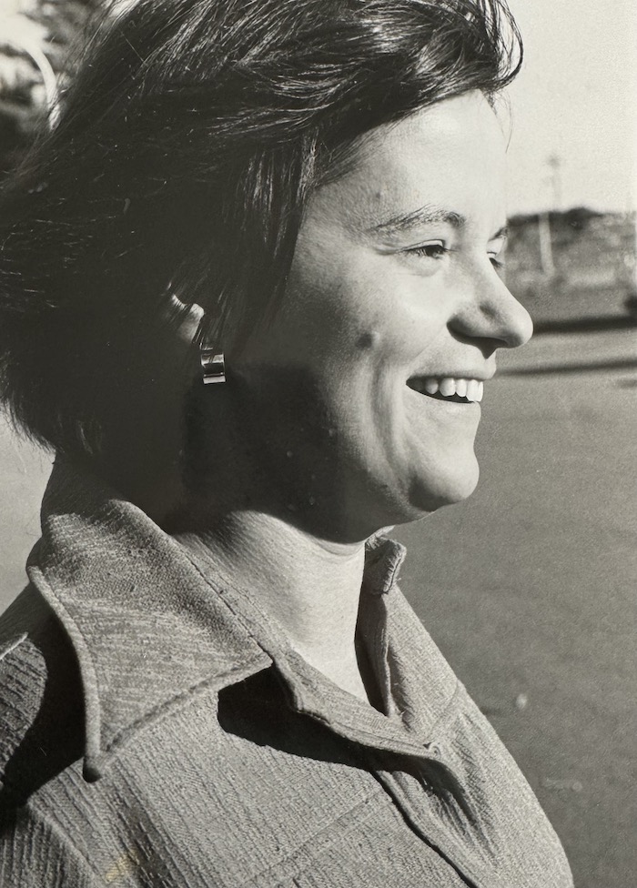Side profile of a person smiling.