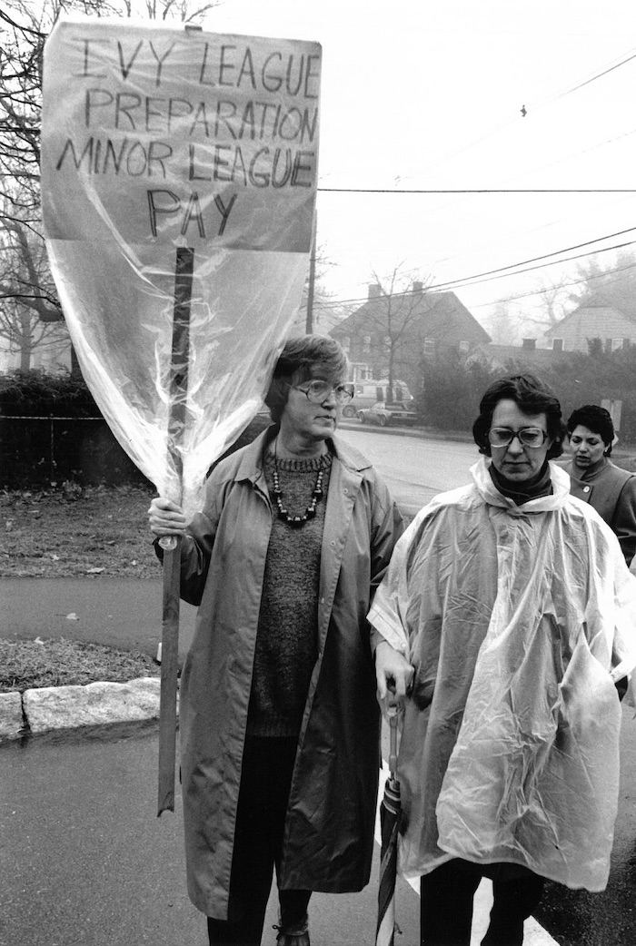 Picketers in the rain with a sign supporting the Lexington strike.