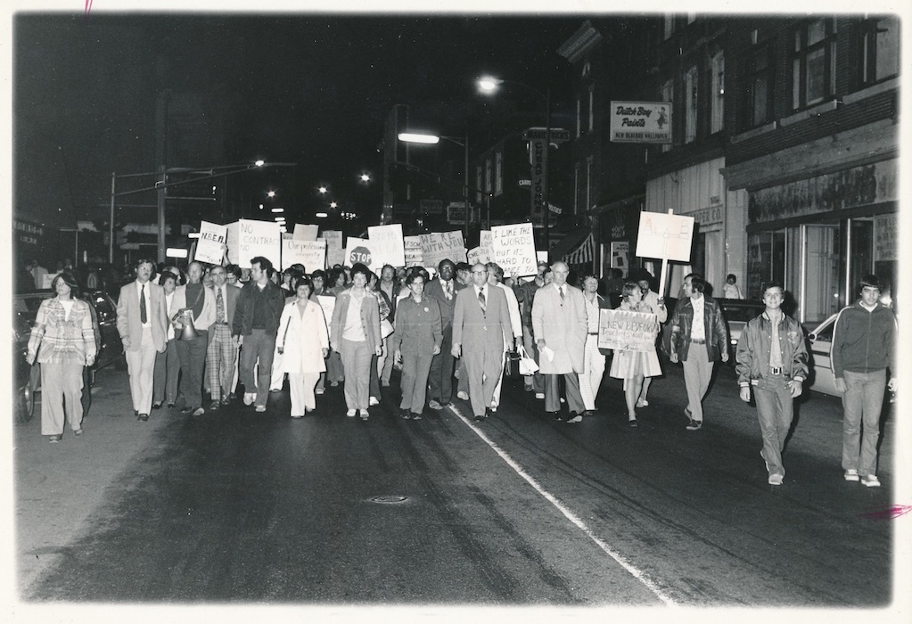 Crowded picket line at night.