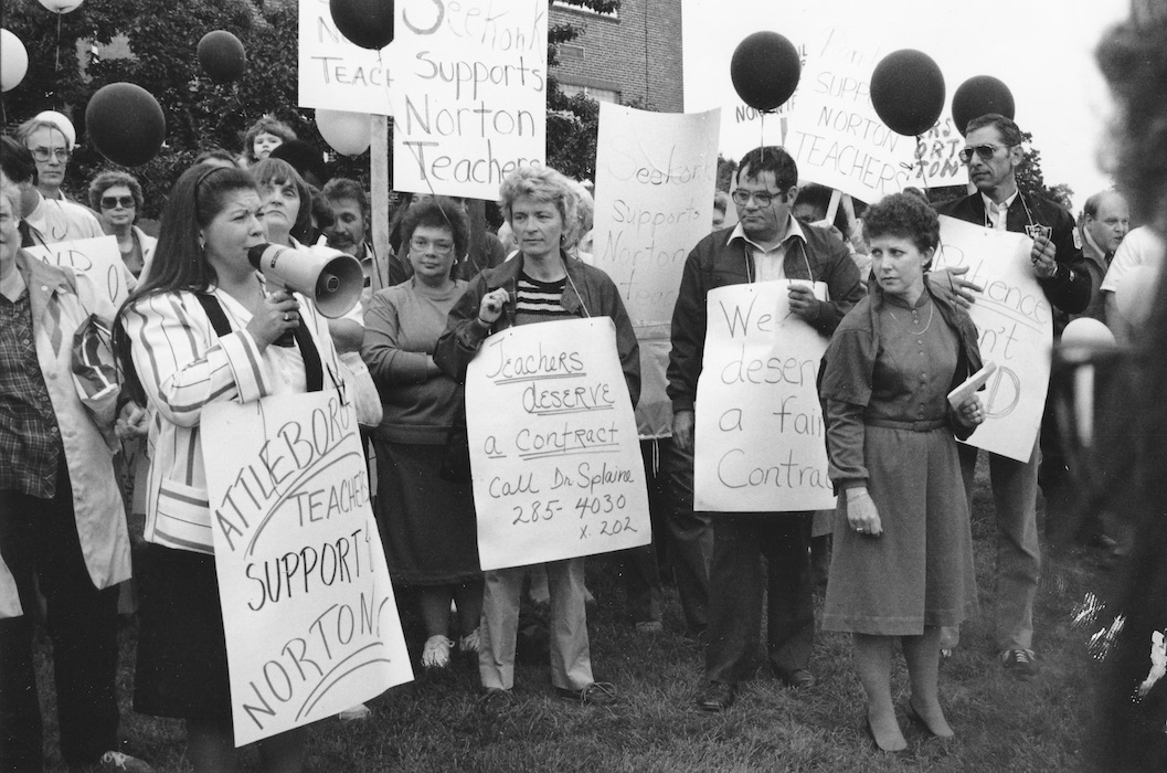 Crowd of picketers with signs supporting the Norton strike.