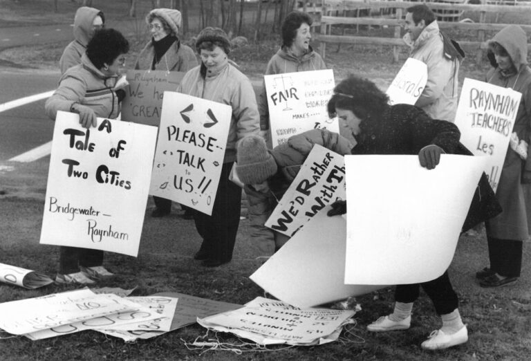 Picketers gathering signs.
