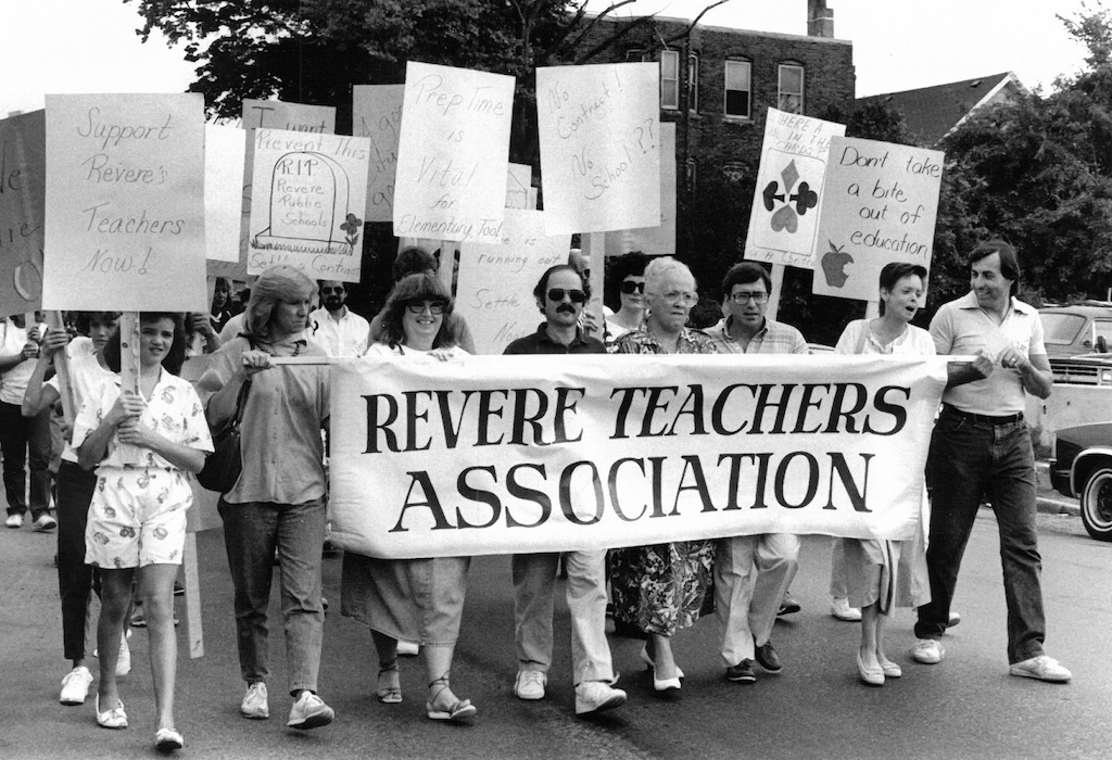 Picketers with signs supporting the Revere strike and a banner for the Revere Teachers Association.