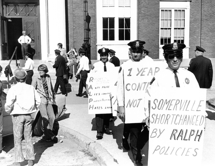 Police officers holding signs.