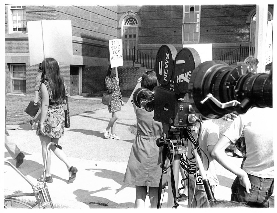 Cameras filming picketers with signs supporting the Somerville strike.