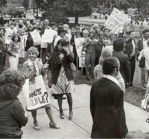 Historic black and white photo of teachers picketing.