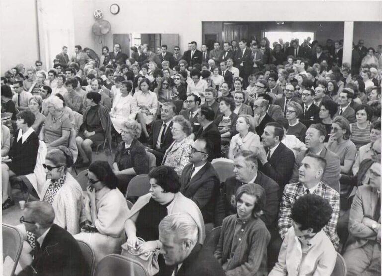 A crowded room full of seated people.